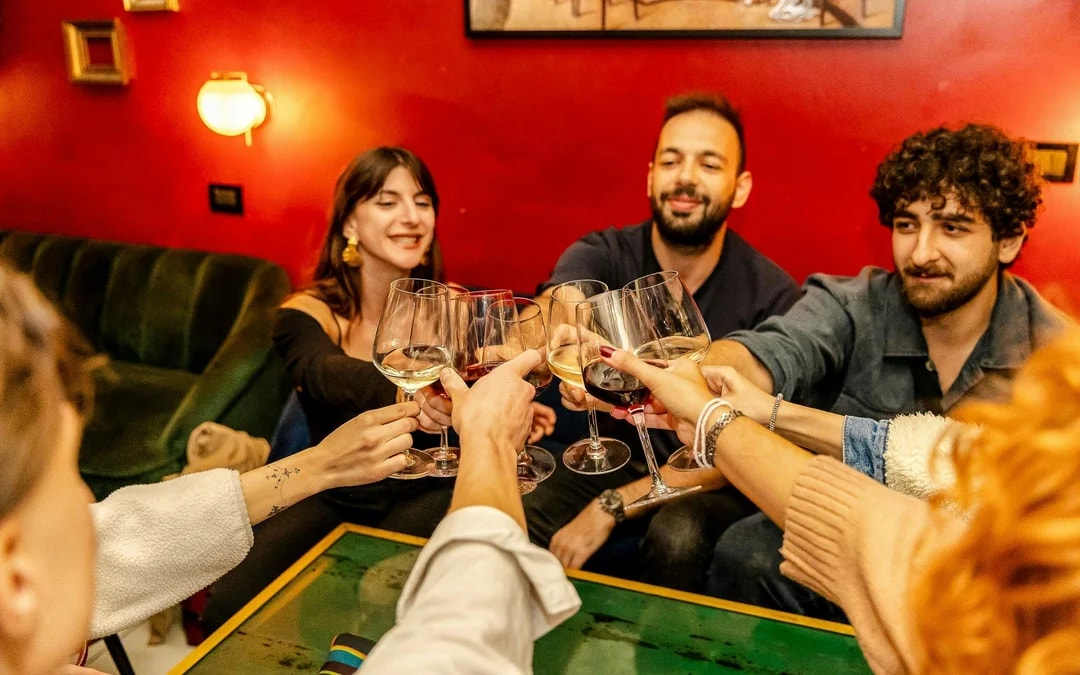Guests toasting with wine glasses at the Tipsy Tour in Rome.