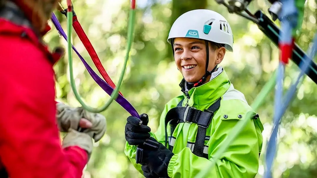 Young participant preparing for Rotorua Forest zipline tour.
