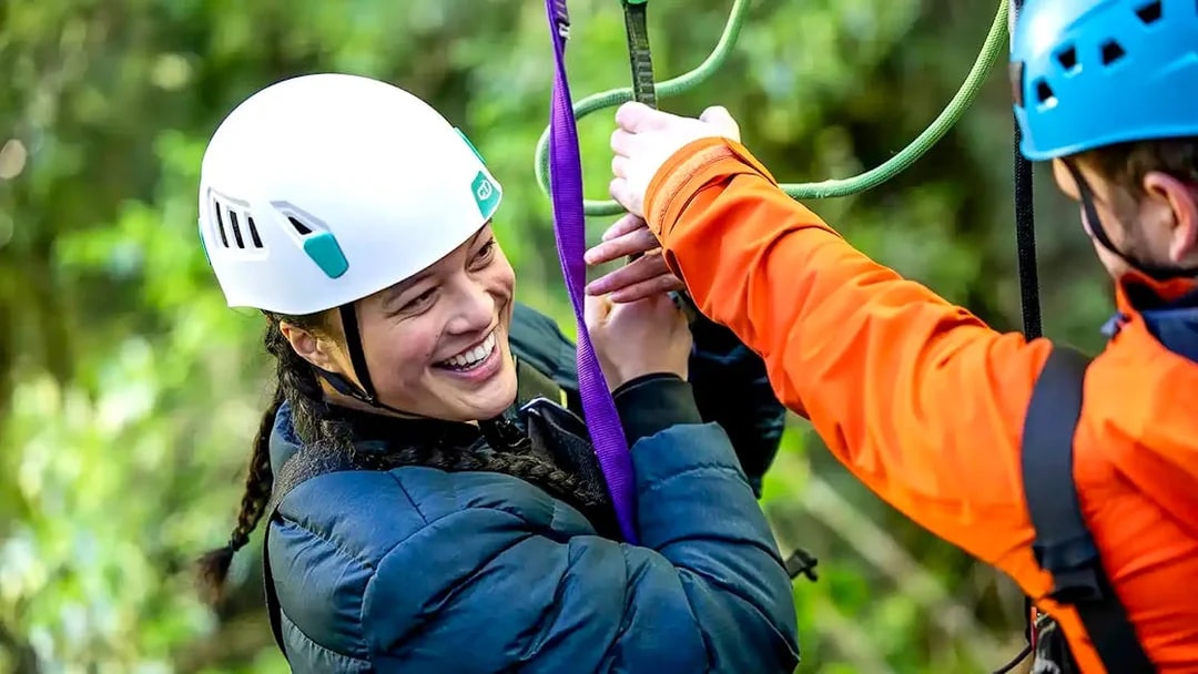 Person enjoying a zipline experience in Rotorua Forest.