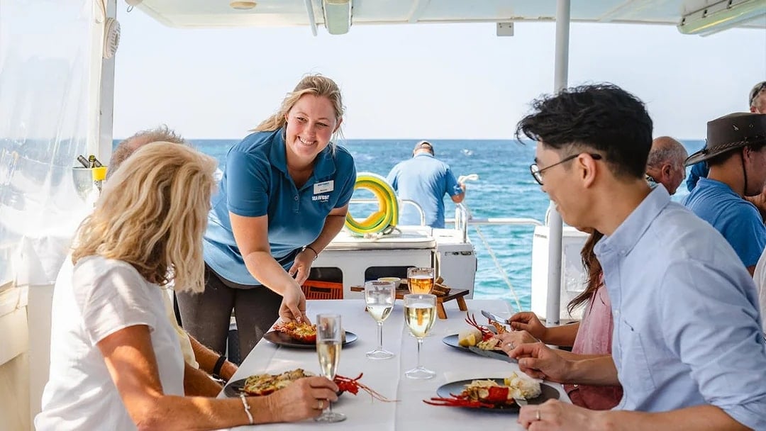 People dining on seafood aboard Luxe Island Cruise.