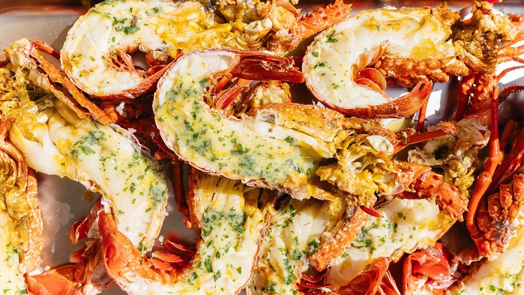 Grilled lobsters with herbs and butter on Rottnest Island Luxe Seafood Cruise.