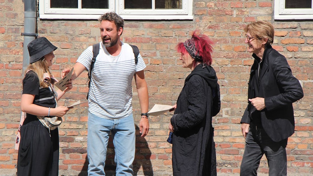 Group discussing clues for Murder Mystery Experience at Round Tower, Copenhagen.