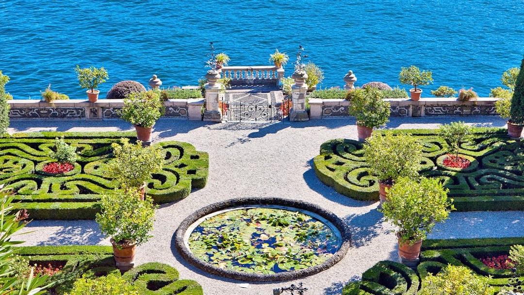 Isola Bella garden with ornate hedges and lily pond overlooking Lake Maggiore.