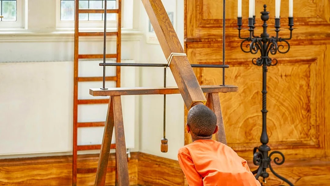 Child observing a historical telescope at Royal Observatory Greenwich.
