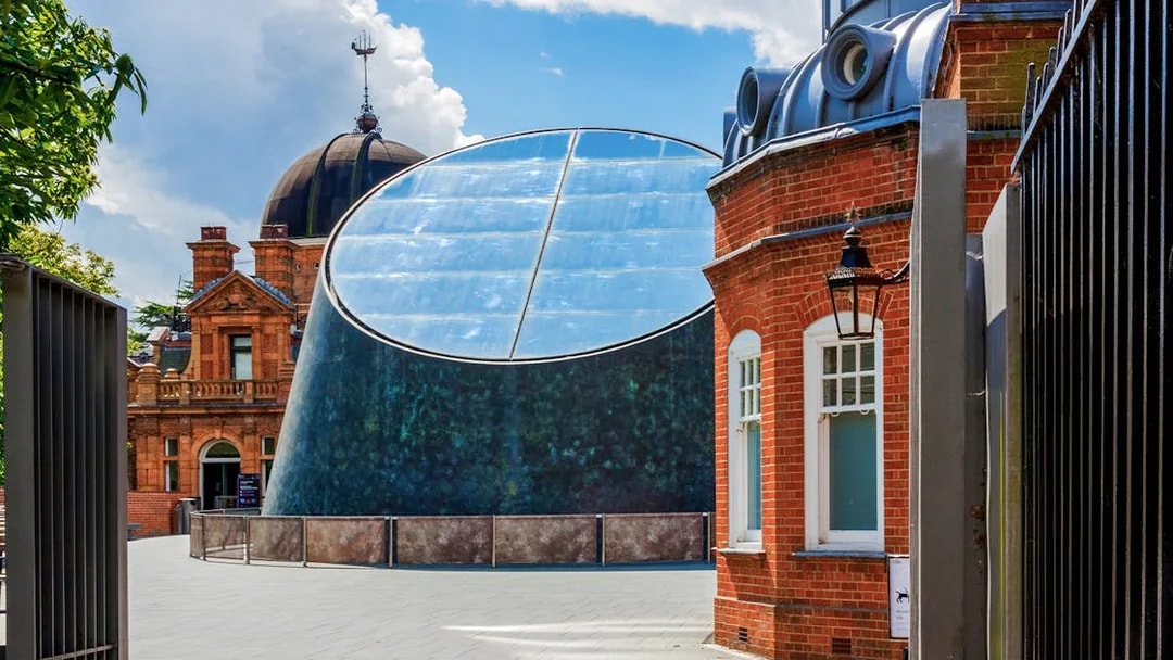 Royal Observatory Planetarium exterior with modern glass dome and historic brick building.