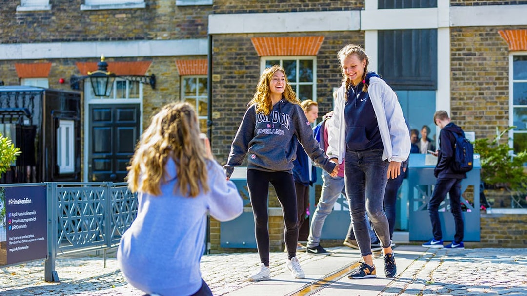 Guests standing on the Prime Meridian line at Royal Observatory Greenwich.