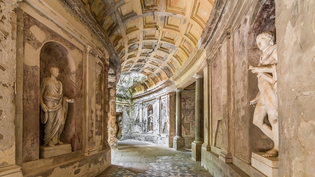 Statues and arched ceiling in the Cryptoporticus, English Garden, Caserta Royal Palace.