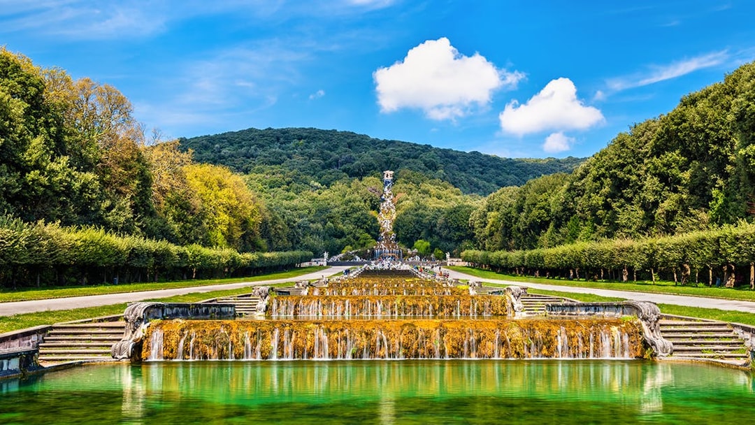 Fountain with sculptures and greenery in the Gardens of Royal Palace of Caserta, Italy.