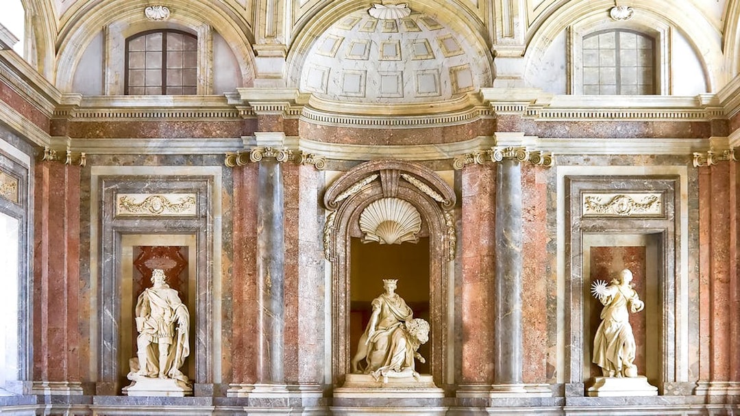 Sculptures atop staircase at Royal Palace of Caserta, Italy.