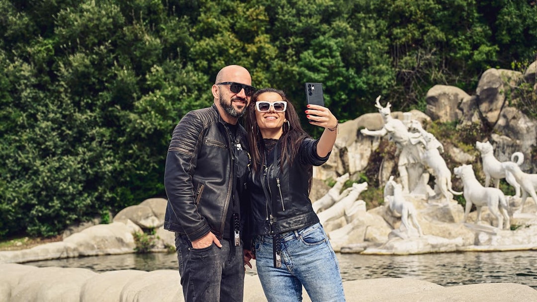 Tourists taking a selfie at the Royal Palace of Caserta fountains, Italy.