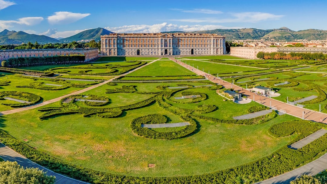Royal Palace of Caserta with expansive gardens and intricate hedges in Caserta, Italy.