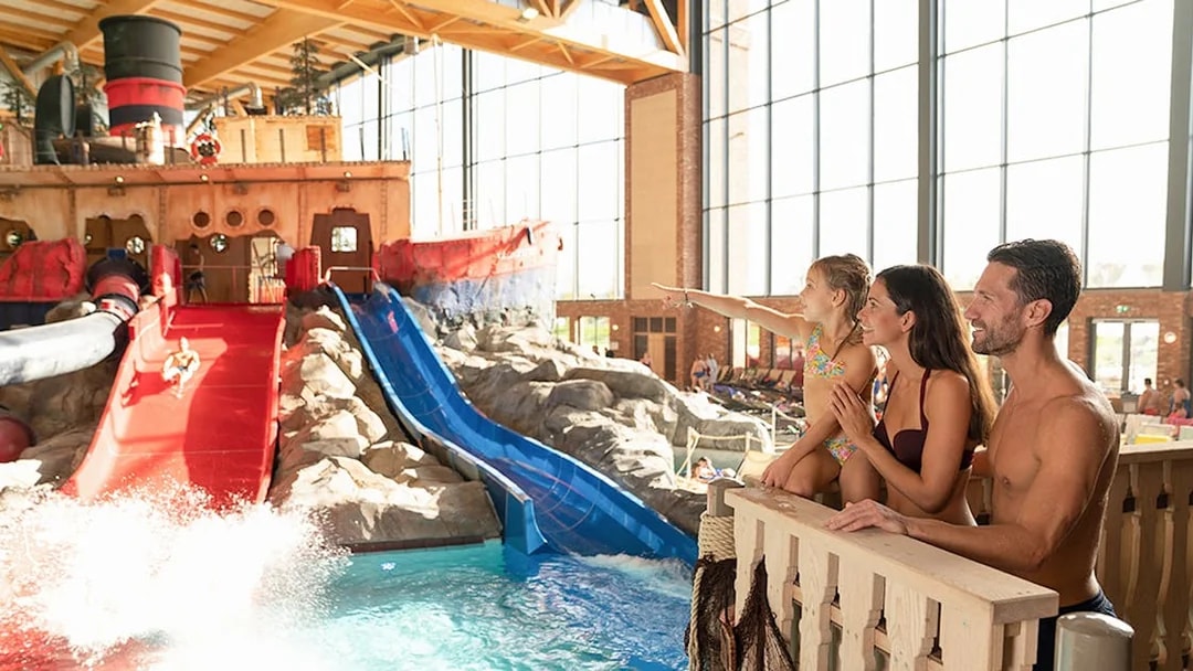 Family enjoying water slides at Rulantica indoor water park.