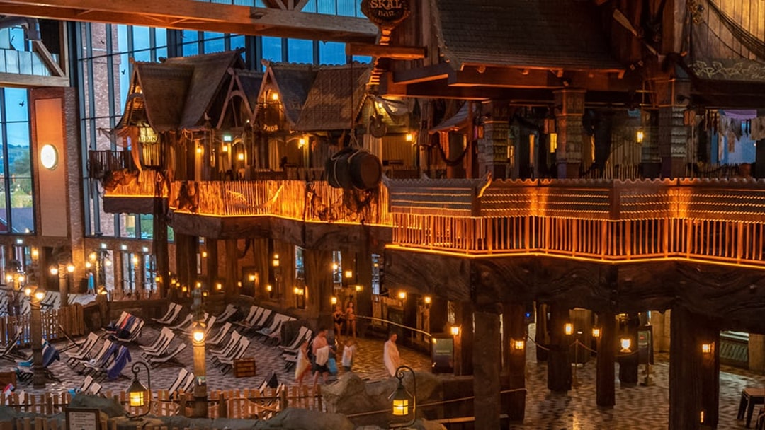 Indoor view of Rulantica water park with themed decor and lounge chairs.