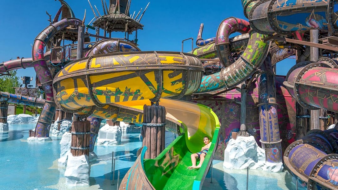 Water slides at Rulantica water park, Germany, with a child enjoying a ride.