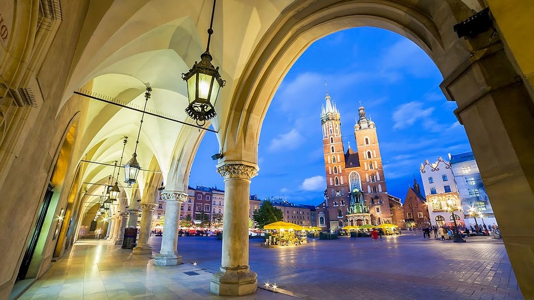 Krakow's Rynek Underground Museum entrance with St. Mary's Basilica in the background.