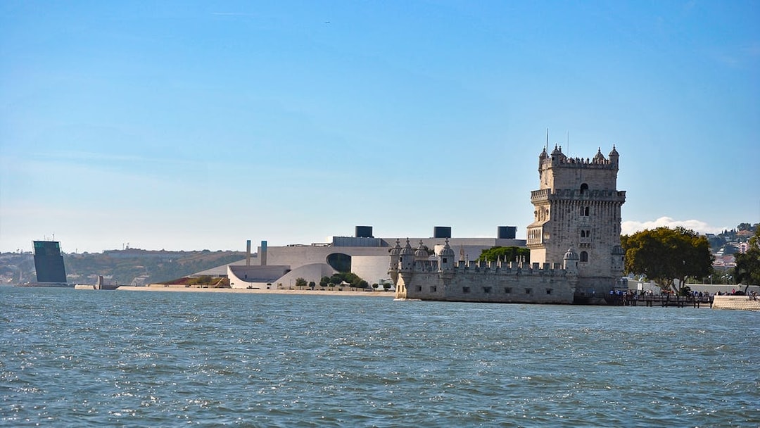 Belém Tower on the Tagus River during a Lisbon sunset sailing tour.