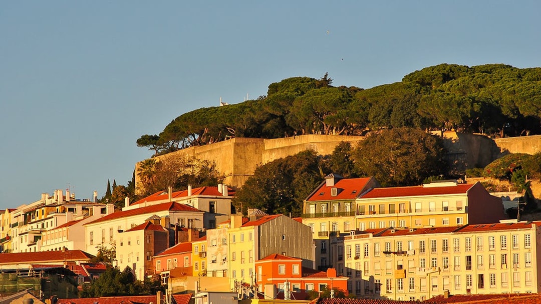 Lisbon's Alfama district with São Jorge Castle viewed from the Tagus River.