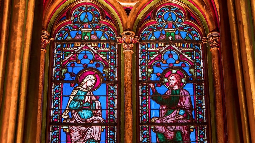 Sainte Chapelle stained glass windows depicting religious figures in Paris, France.