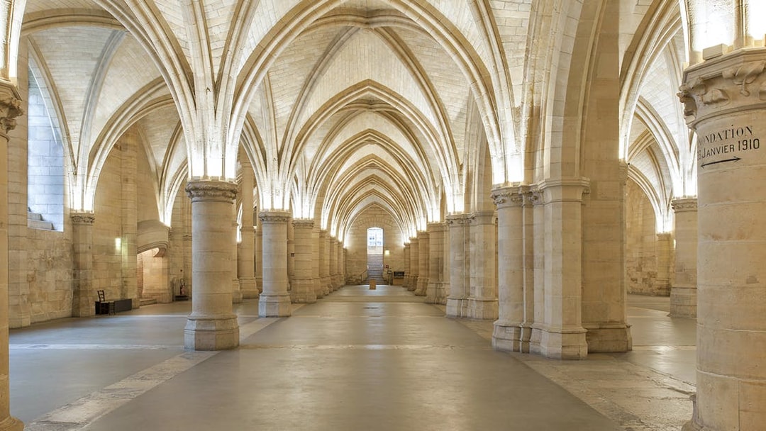 Gothic arches inside the Conciergerie, Paris, with priority access tickets available.