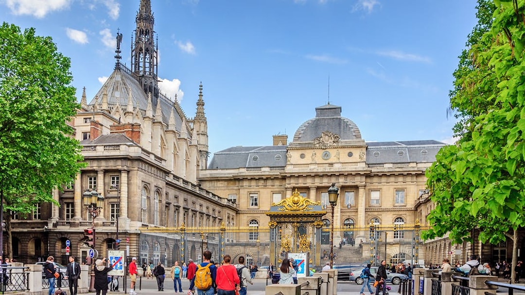 Sainte Chapelle exterior with ornate spire and surrounding architecture in Paris.