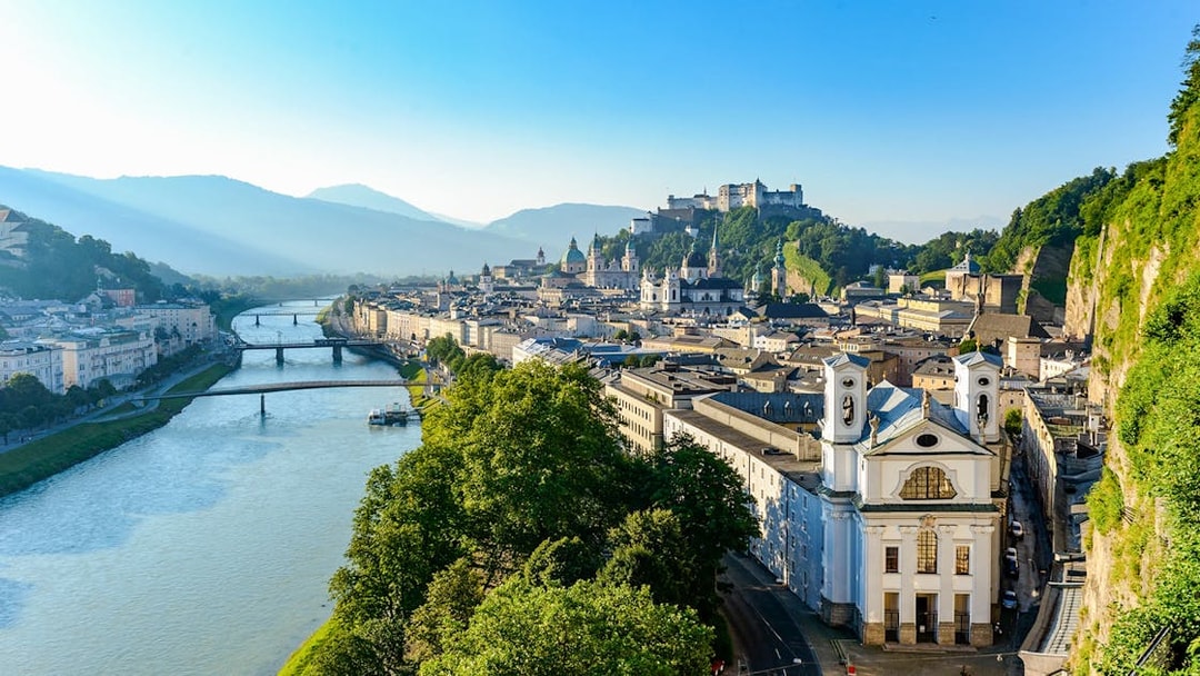 Salzburg cityscape with Hohensalzburg Fortress and Salzach River, view from above.