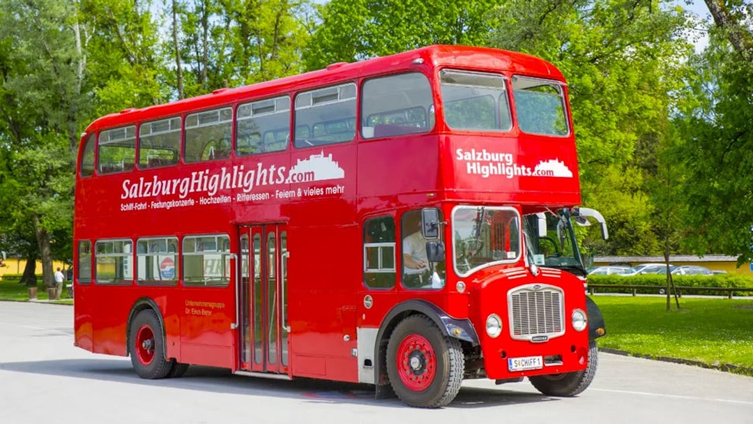 Red double-decker bus for Salzburg River Cruise and Hellbrunn Palace tour.