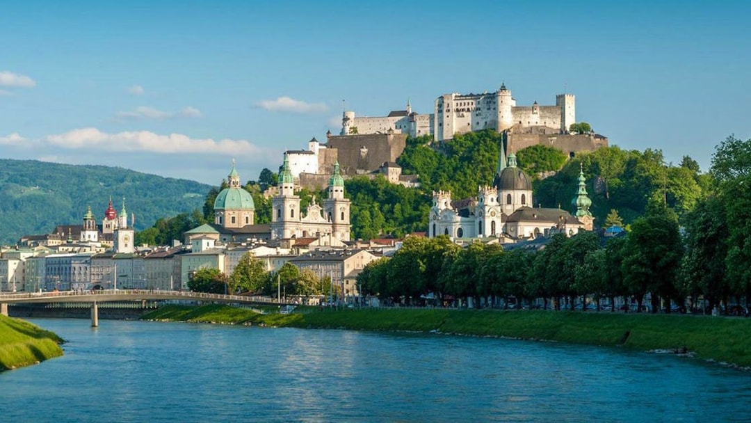 Salzburg cityscape with Hohensalzburg Fortress and Salzach River, view from Hop On Hop Off City Tour.