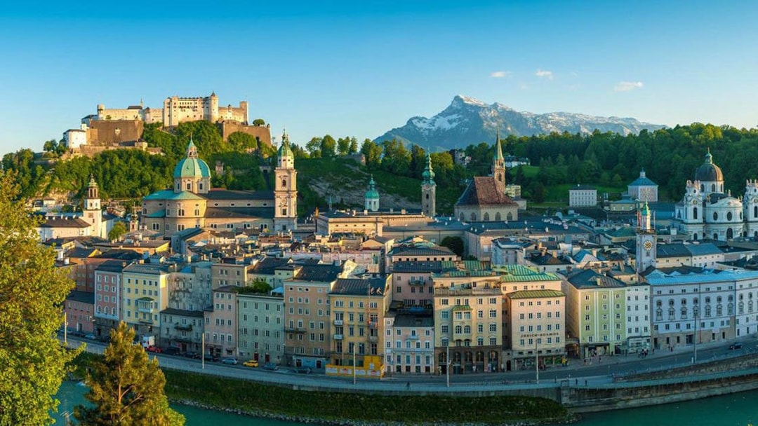 Salzburg cityscape with Hohensalzburg Fortress and Alps, view from Hop On Hop Off Yellow Line.