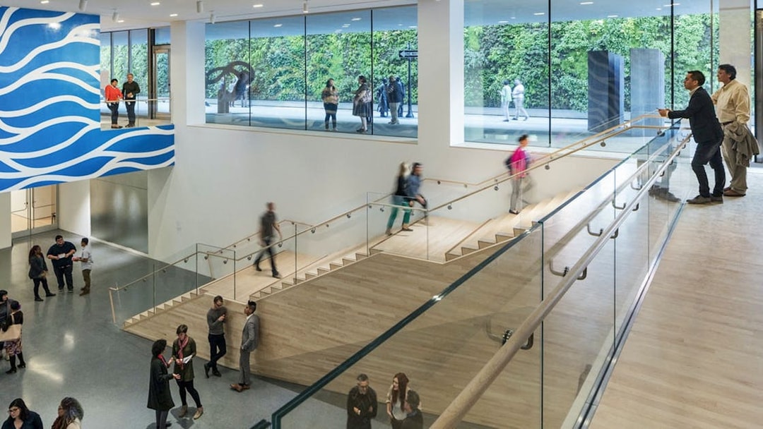 Visitors inside San Francisco Museum of Modern Art with modern architecture and art displays.