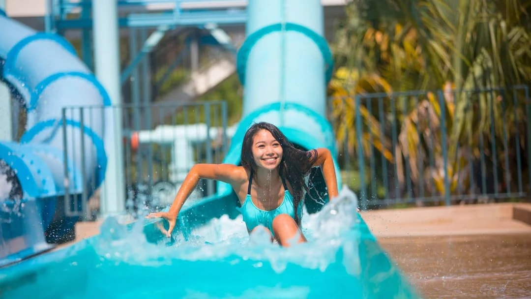 Person enjoying a water slide at a San Francisco amusement park.