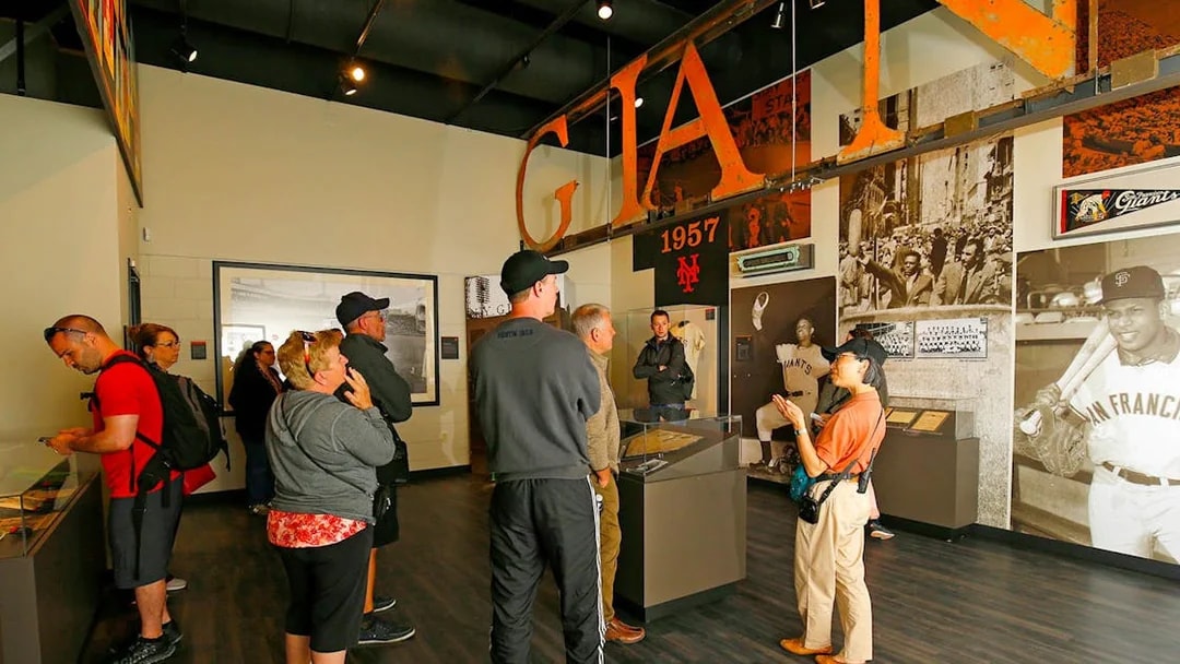 Visitors exploring San Francisco Giants memorabilia at Oracle Park museum.