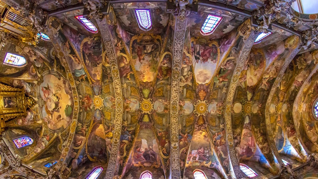 San Nicolas Church ceiling with intricate frescoes and stained glass windows, Valencia, Spain.