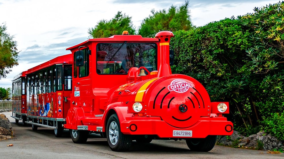 Red tourist train on a scenic route for a panoramic train tour.