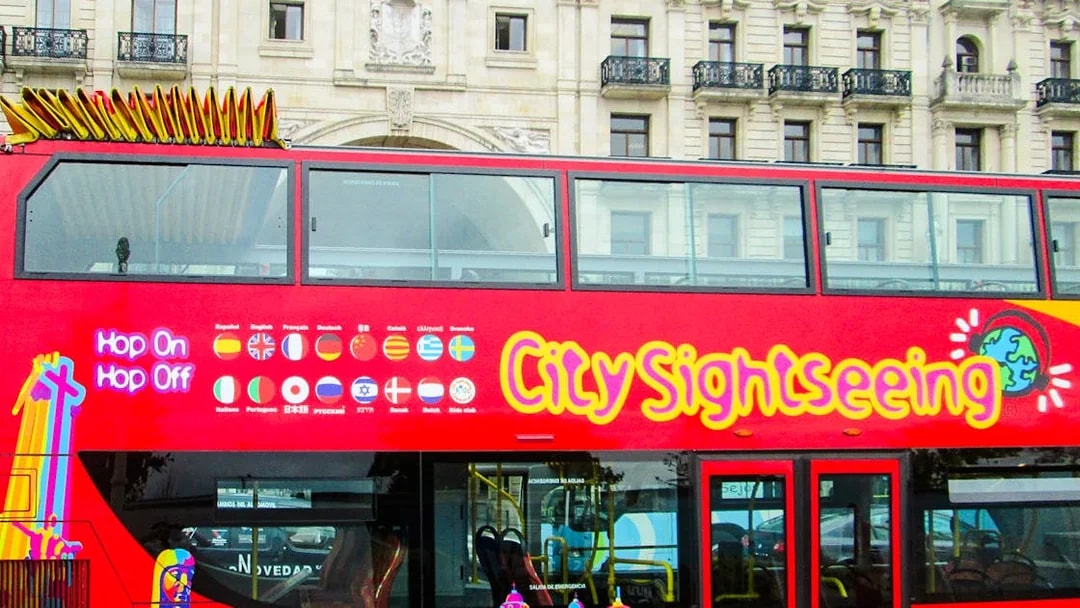 Red double-decker bus for City Sightseeing tour in Santander, featuring hop-on hop-off service.