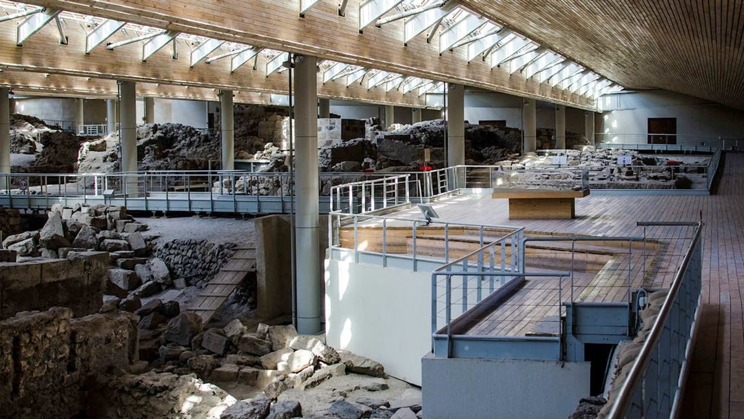 Akrotiri Archaeological Site interior with ancient ruins and walkways in Santorini, Greece.