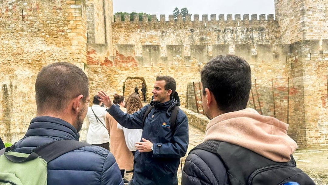 Tour guide leading a group at São Jorge Castle, Lisbon.