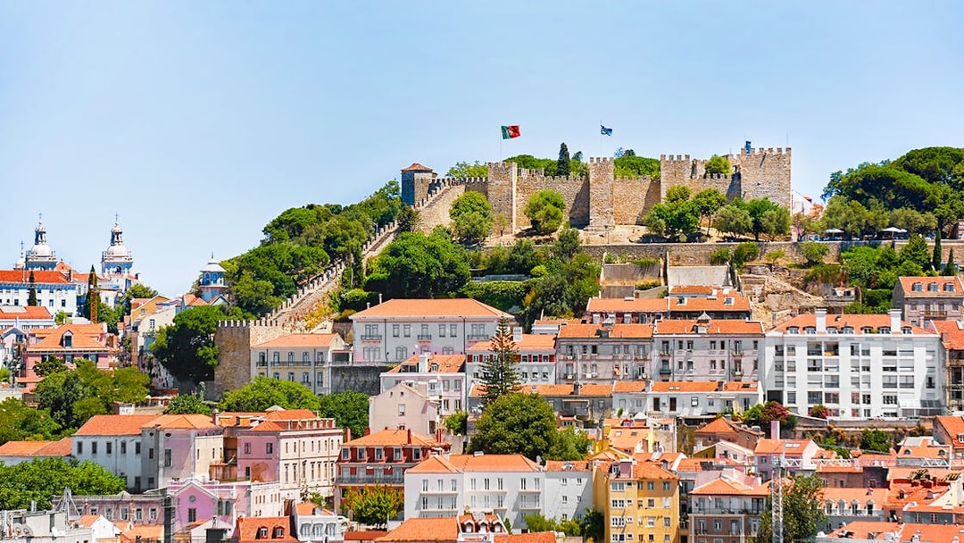Aerial view of Sao Jorge Castle in Lisbon with surrounding cityscape.