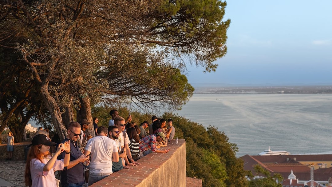 Visitors enjoying the view from St. George’s Castle overlooking Lisbon and the Tagus River.