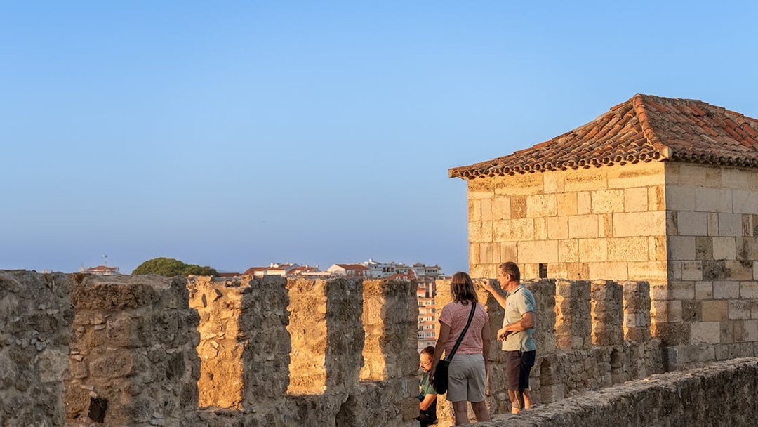 Visitors exploring the ancient walls of St George's Castle in Lisbon.