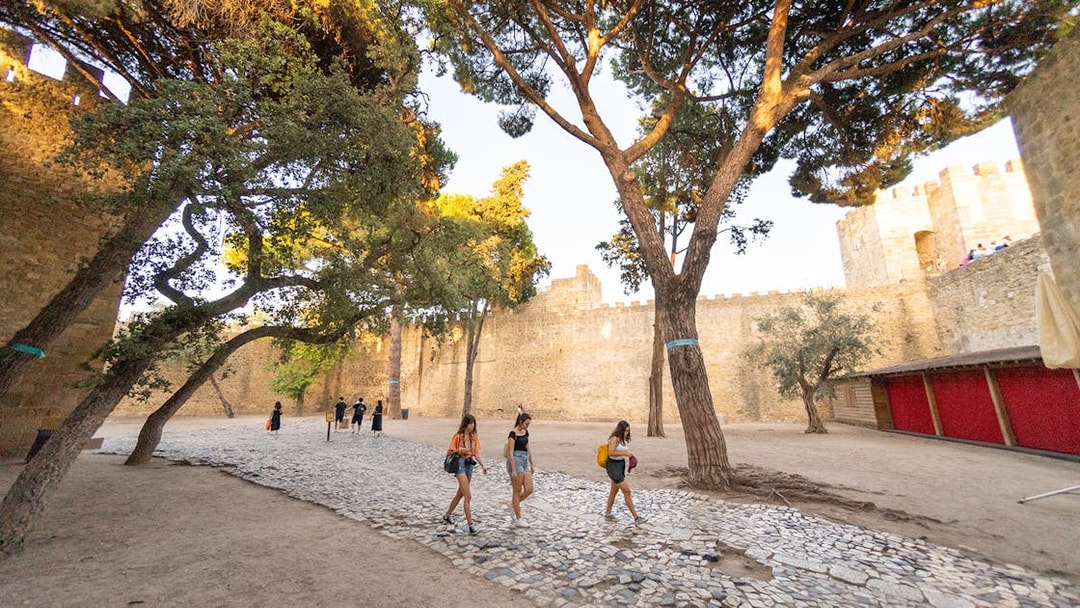 Visitors walking along the cobblestone path inside St. George’s Castle, Lisbon.