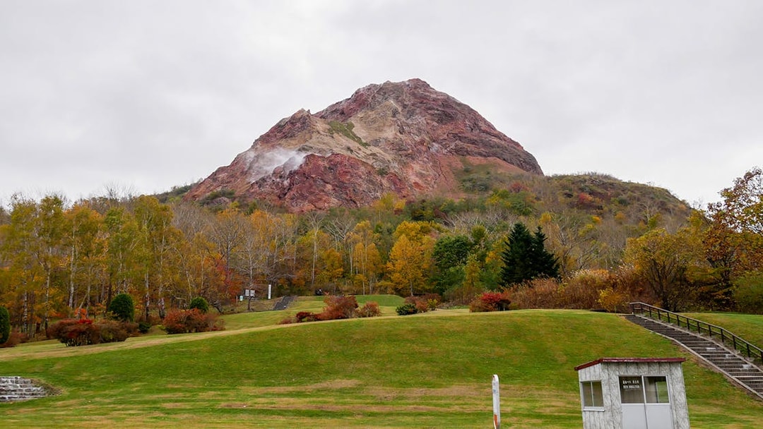 Mount Usu with autumn foliage in Noboribetsu, Japan, part of a guided day trip from Sapporo.