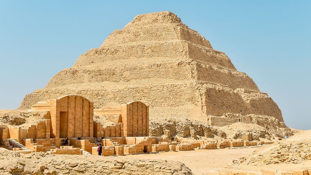 Step Pyramid of Djoser at Saqqara, Egypt under a clear sky.