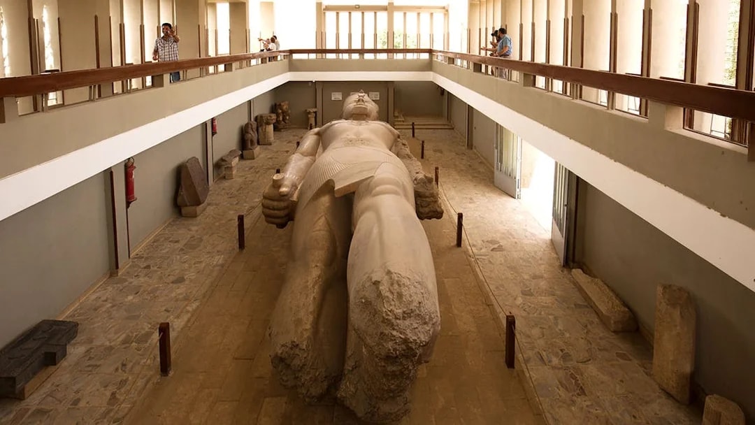 Tourists view the colossal statue of King Ramses II at the open-air museum in Memphis, Egypt.
