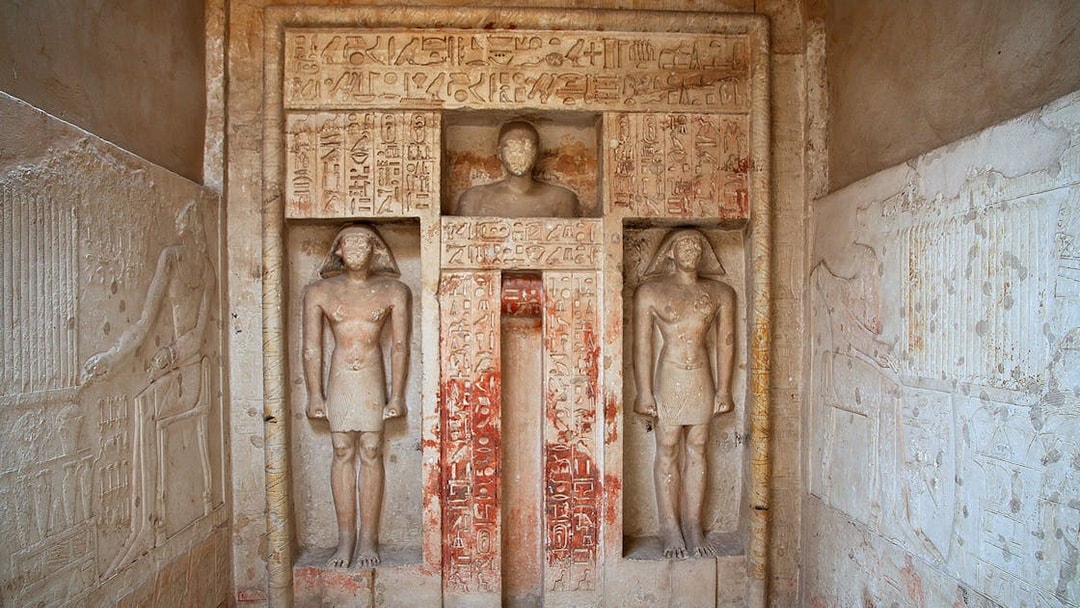 Ancient Egyptian statues and hieroglyphs in Saqqara necropolis, Egypt.