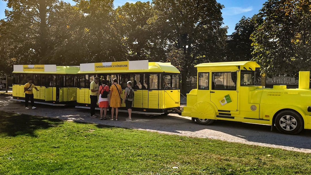Panorama train at Schönbrunn Palace with visitors boarding.