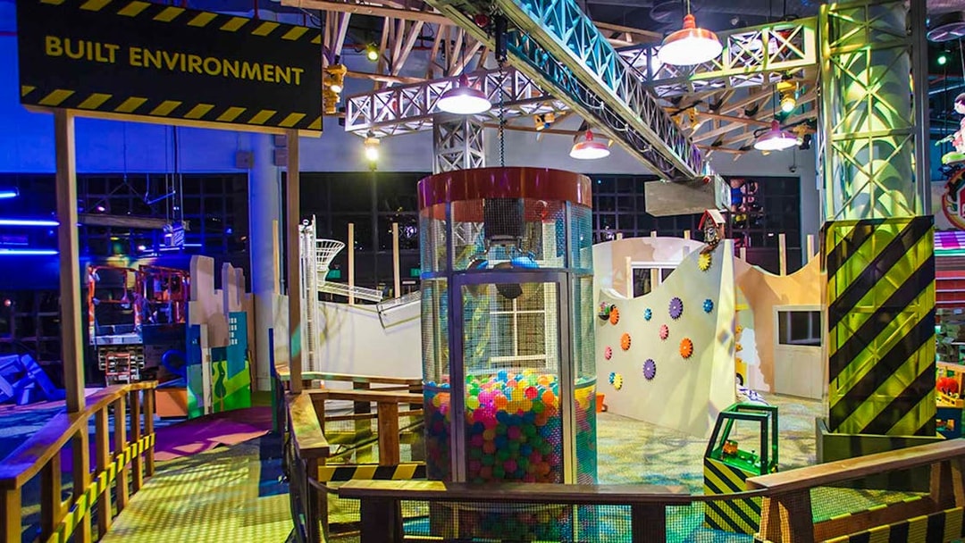 Interactive exhibit at Science Centre Singapore featuring colorful gears and play area.