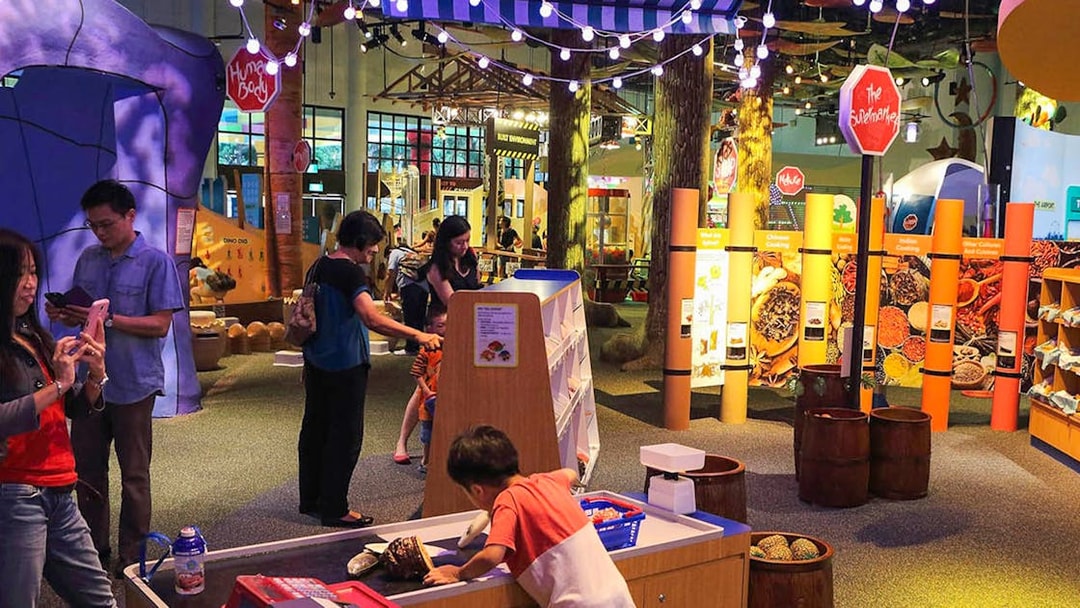 Interactive exhibit at Science Centre Singapore with visitors exploring displays.