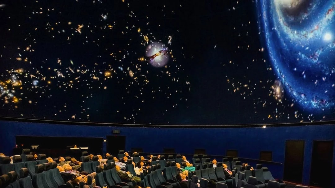 Visitors watching an interactive galaxy show at Scienceworks planetarium.
