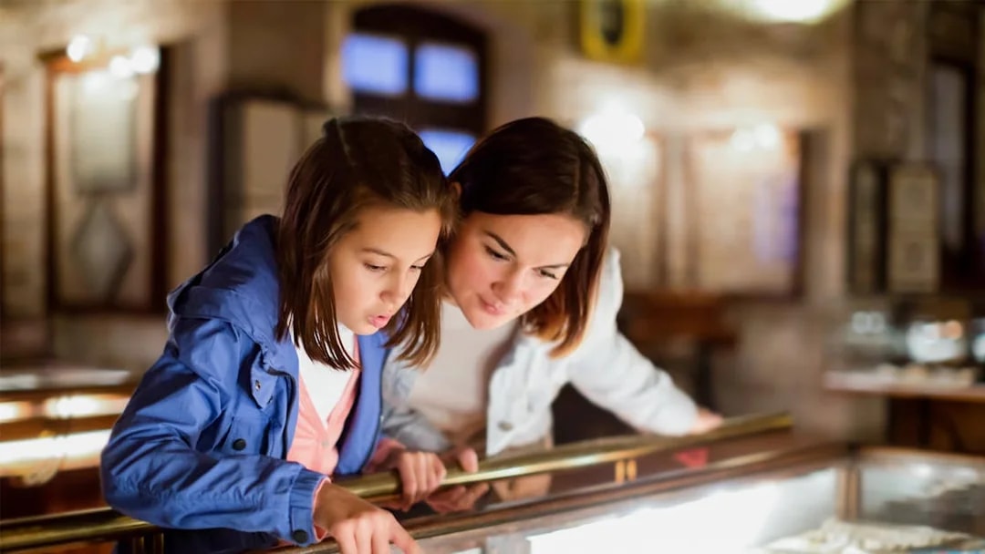 Mother and daughter examining exhibit at Sciencework museum.