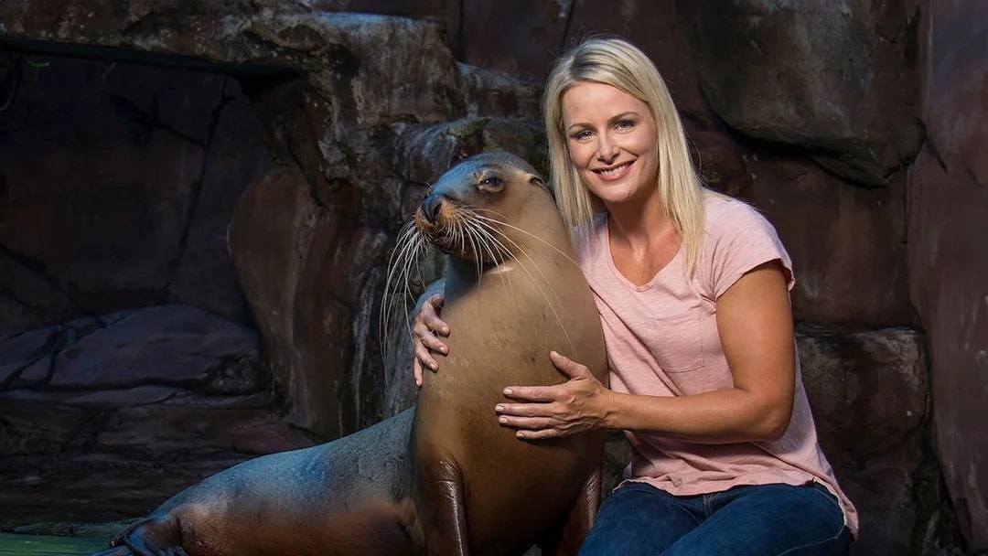 Woman interacting with a seal at SEA LIFE Sunshine Coast.